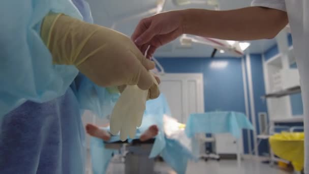 Midsection Close Unrecognizable Surgeon Helping His Assistant Put Sterile Gloves — Stock Video