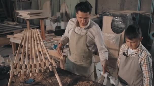 Medium Footage Father Son Finishing Working Wooden Diy Deck Chair — Video Stock