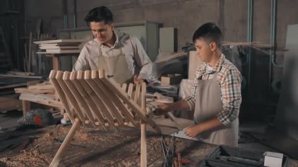 Medium Shot Adult Man Working Carpenter His Little Son Making — Vídeo de Stock