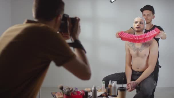 Medium Shot Male Stylist Putting Red Ruff Neck Shirtless Male — Stock Video