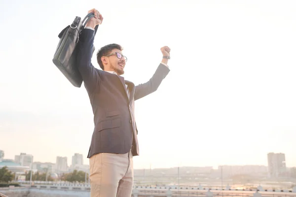 Young Excited Businessman Black Leather Handbag Expressing Triumph Front Camera — Fotografia de Stock