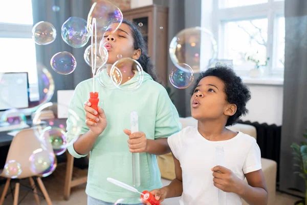 Cute Siblings Casualwear Blowing Group Soap Bubbles Various Sizes While — Foto Stock