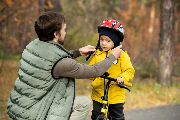 Young Man Fastening Belt Safety Helmet Head His Cute Little — Stock Photo, Image