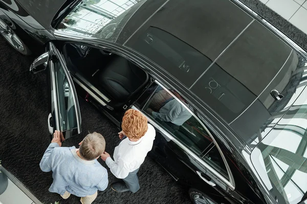 View Young Salesman Auto Center Opening Door Black Vehicle While — Stockfoto