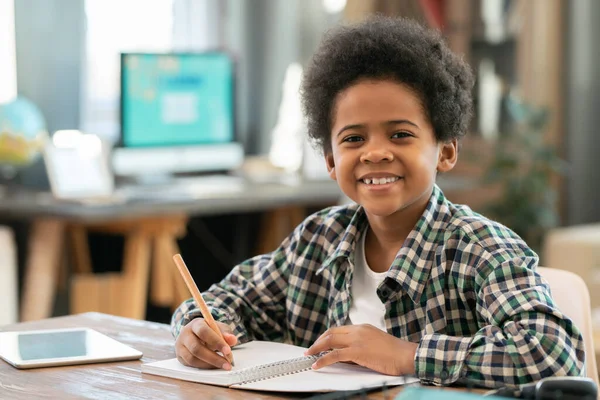 Adorable Schoolboy African Ethnicity Making Notes Copybook Looking You Smile — Fotografia de Stock
