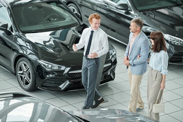 Confident Young Male Manager Luxurious Auto Center Consulting Modern Couple Stock Photo