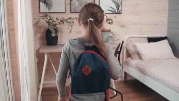 Tracking Shot Little Schoolgirl Walking Her Room Putting Her Backpack — Stock Video