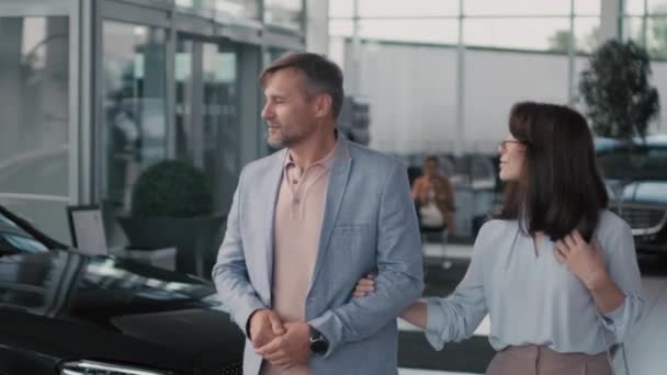 Handheld Tracking Posh Couple Walking Together Dealership Looking Cars While — Stock Video