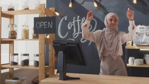 Medium Shot Joyful Muslim Saleswoman Working Cozy Coffee Shop Dancing — Stock Video
