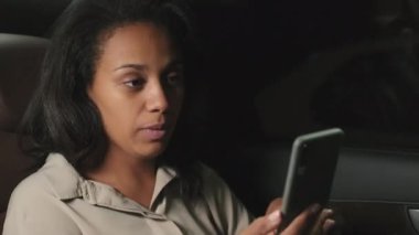 Gece taksinin arka koltuğunda eve dönerken arkadaşlarıyla akıllı telefondan görüntülü konuşma yapan iş kadını gibi.