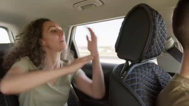 Playful Young Woman Sitting Car Her Boyfriend Enjoying Listening Music — Stock Video