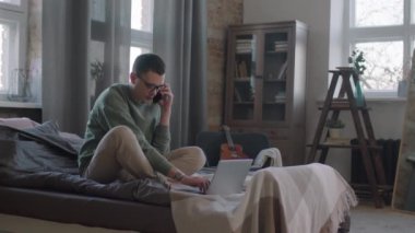 Kafkasyalı, yatakta bacak bacak bacak üstüne atmış, dizüstü bilgisayarla çalışırken telefonla konuşan bir adamın yavaş çekim görüntülerini tarıyorum.