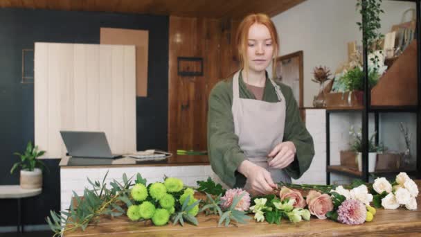 Medium Portrait Pretty Young Woman Standing Wooden Desk Small Flower — Stock Video