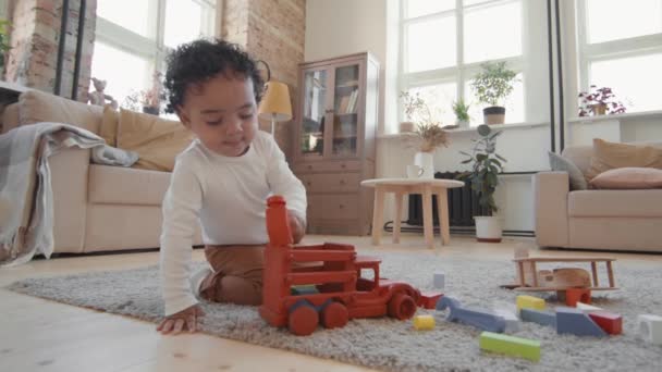 Handheld Shot Slowmo Adorable Baby Boy Sitting Rug Cozy Living — Stock Video