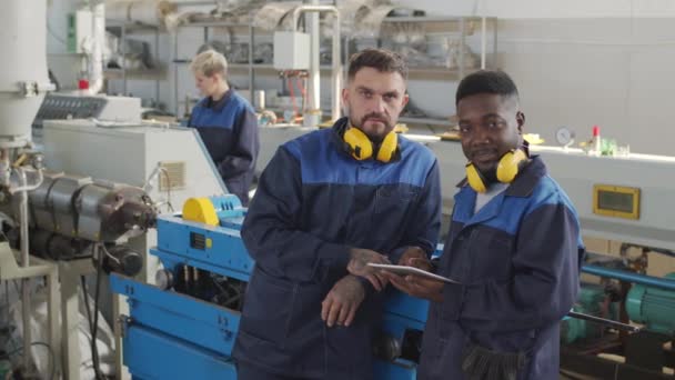 Portrait Shot Tracking Male Plant Workers Wearing Uniforms Noise Canceling — Stock Video