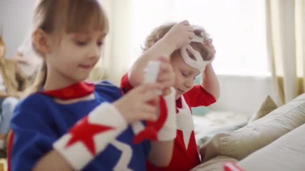 Medium Closeup Kids Putting Superhero Eye Masks Laughing Out Loud — Stock Video