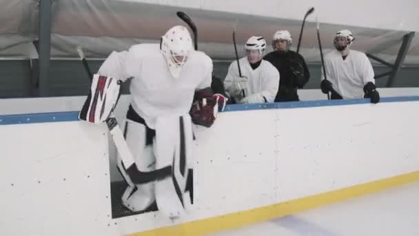 Полный Кадр Команды Хоккеистов Мужчин Сидящих Скамейке Запасных Выходящих Лед — стоковое видео