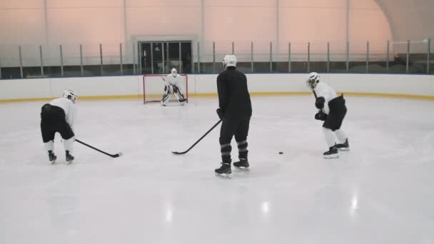Full Rear View Shot Male Hockey Players Practicing Puck Shootings — Stock Video
