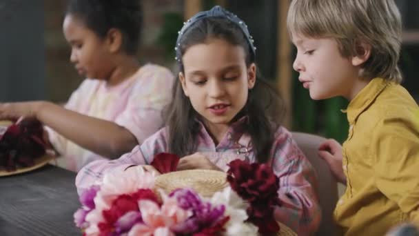 Medium Shot Cute Girls Boy Decorating Straw Hats Flowers While — Stock Video