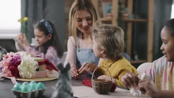 Handheld Shot Cheerful Young Woman Three Kids Making Easter Decorations — Stock Video