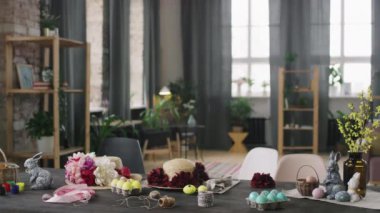 Paskalya süslemeleri ve süslemeleri ahşap masanın üzerinde duran atölyenin içinin PAN karesi.