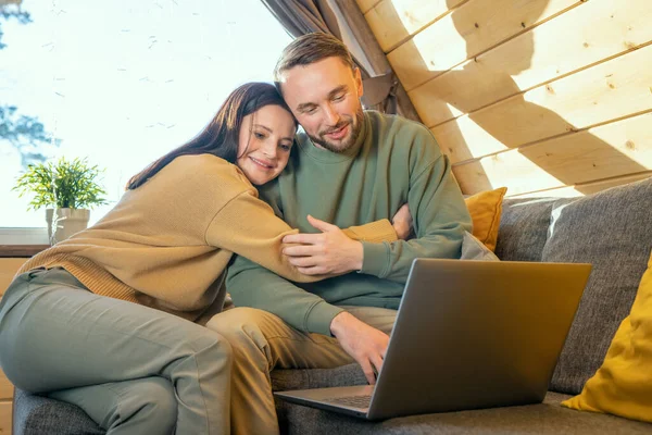 Happy Young Woman Casualwear Embracing Her Husband While Both Sitting — Stock Photo, Image