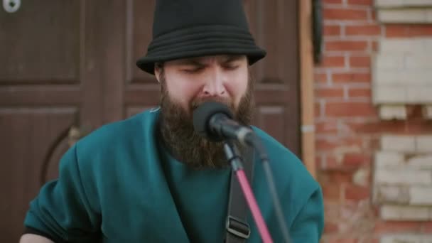 Handheld Tilt Shot Bearded Male Musician Playing Acoustic Guitar Singing — Stock Video