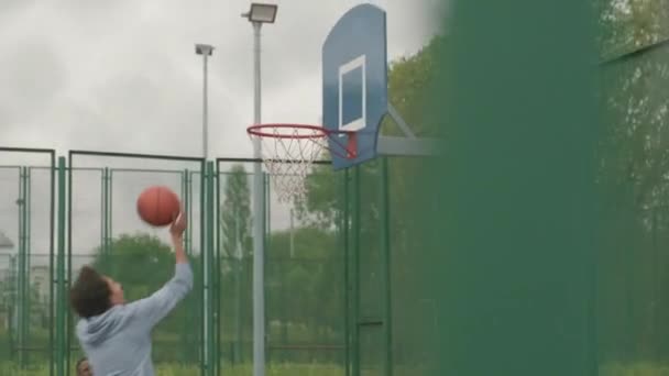 Seguimiento Lentitud Portátil Hombre Joven Saltando Lanzando Pelota Canasta Mientras — Vídeos de Stock