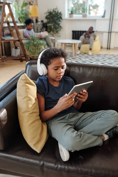 Adorable Little Boy Headphones Sitting Black Leather Couch Pillow Looking — Stock Photo, Image
