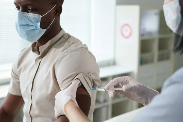 Gloved Hand Nurse Uniform Protective Mask Vaccinating African Guy Sitting — Stock Photo, Image