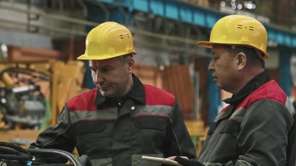 Medium Shot Two Male Plant Workers Hard Hats Uniforms Talking — Stock Video