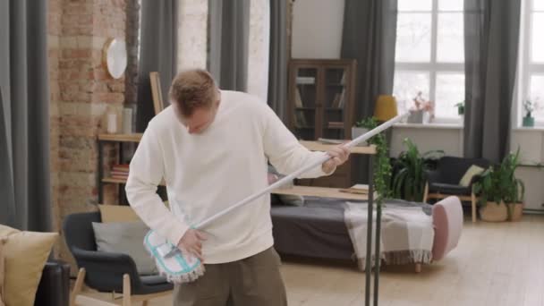 Medium Shot Handsome Young Man Holding Mop Dancing While Pretending — Stock Video