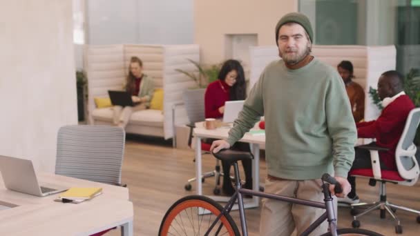 Slowmo Pan Joven Barbudo Start Trabajador Oficina Con Bicicleta Posando — Vídeos de Stock