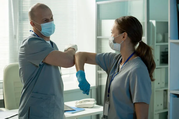 Fiduciosi Chirurghi Scrub Guanti Sterili Piedi Tavola Ufficio Moderno Toccando — Foto Stock