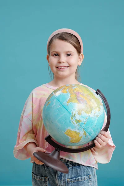 Portrait Little Schoolgirl Globe Smiling Camera Standing Blue Background — Stock Photo, Image