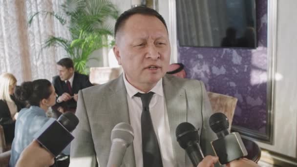 Waist Shot Middle Aged Asian Businessman Being Interviewed Journalists Speaking — Stock video