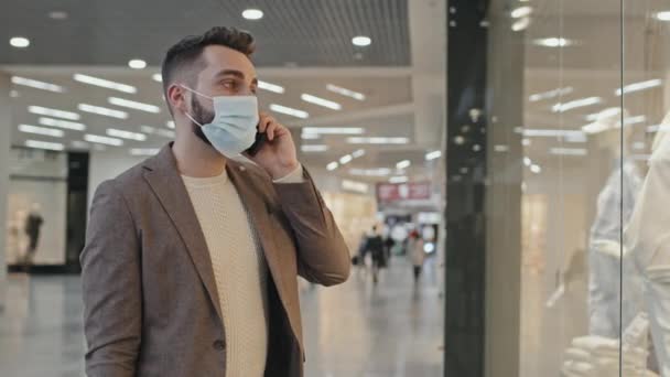 Medium Shot Young Handsome Man Face Mask Talking Phone Standing — Stock Video