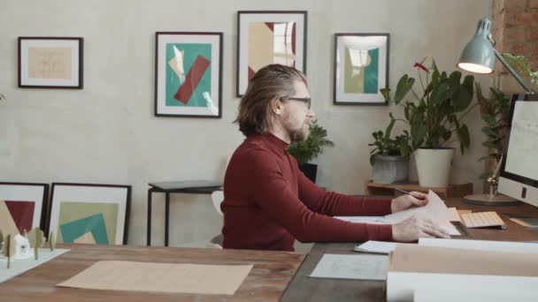 Pan Seitenansicht Mit Einem Bärtigen Kaukasischen Architekten Der Schreibtisch Sitzt — Stockvideo