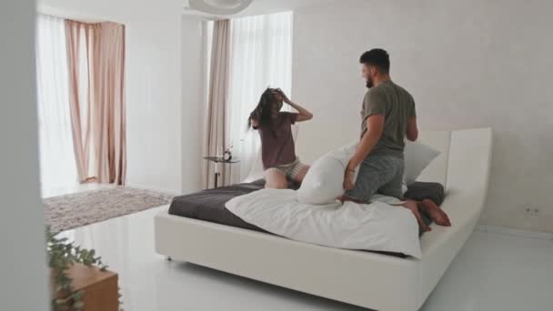 Wide Shot Young Romantic Couple Hugging Passionate Pillow Fight Bed — Stock Video