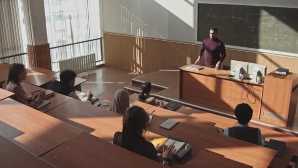 고등학교 학생들은 학생들의 느림보로 대규모 강의실에서 교수와 기하학 수업을 답하기 — 비디오