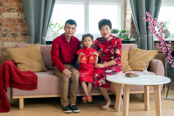 Young affectionate family sitting on sofa — Stock Photo, Image