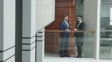 İki başarılı iş ortağının ya da avukatın yavaşlığıyla PAN tam çekim modern ofisin ikinci katında demiryolu ile sohbet ederken