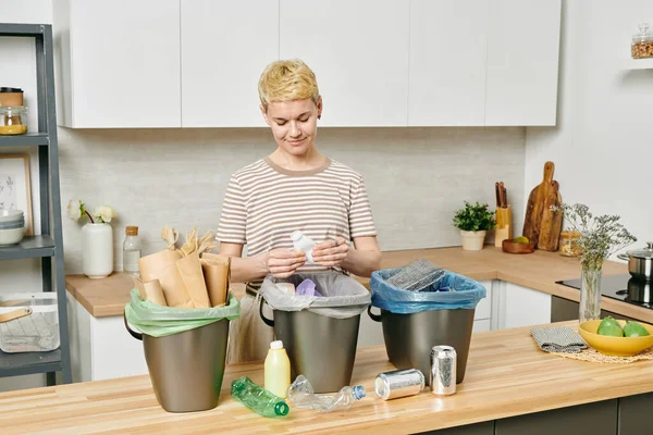 Pretty female sorting various kinds of trash — Stock Photo, Image