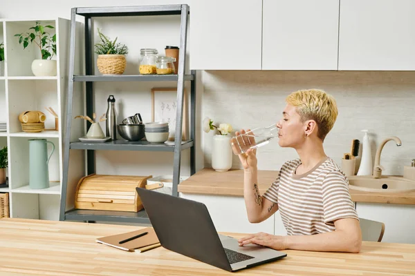 Attractive blond female drinking pure water — Stock Photo, Image