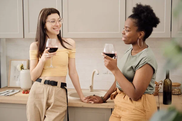 Deux jolies femmes grillent avec des verres de vin rouge — Photo