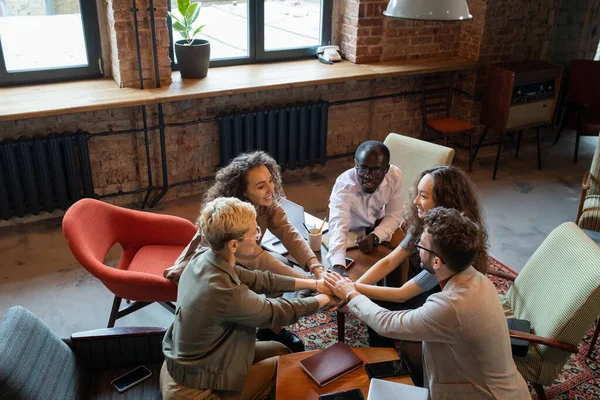 Several multiracial colleagues keeping hands on top of each others — Stock Photo, Image