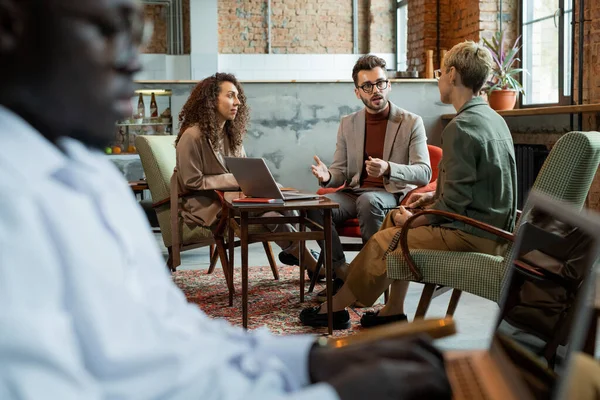 Three managers discussing their ideas by table — Stock Photo, Image