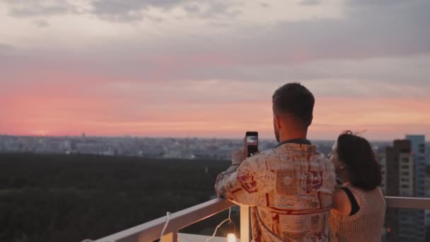 Handheld Tracking Rear View Young Man Taking Photo Sunset While — Stock Video