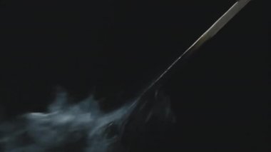 Siyah arka planda uzun kibrit yakma ve sonra söndürme aşırı yakın çekim