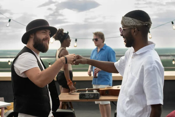 Two young intercultural men greeting each other by punch bump — Stock Photo, Image